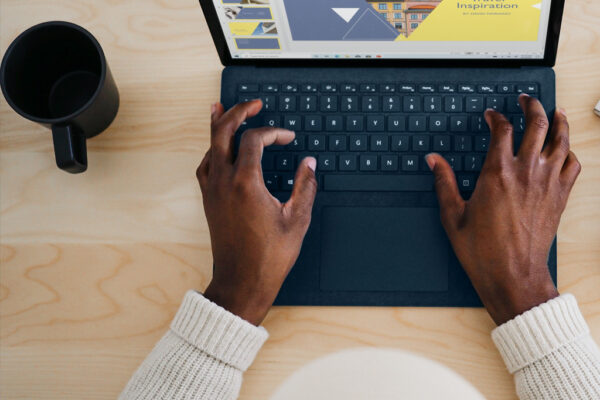 Hands typing on laptop
